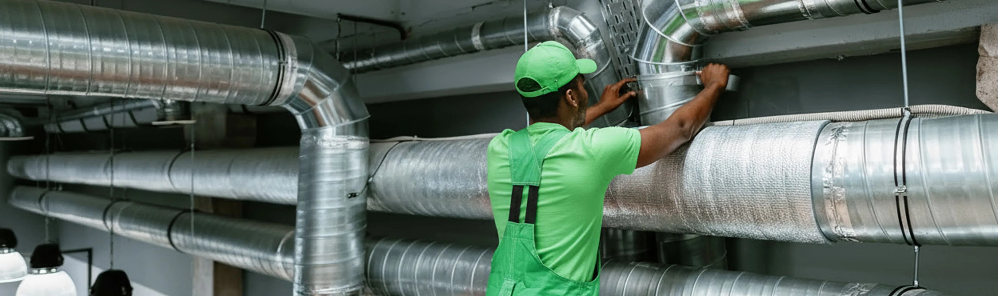 Rapid Response team member installing and securing large commercial air ductwork inside an industrial building