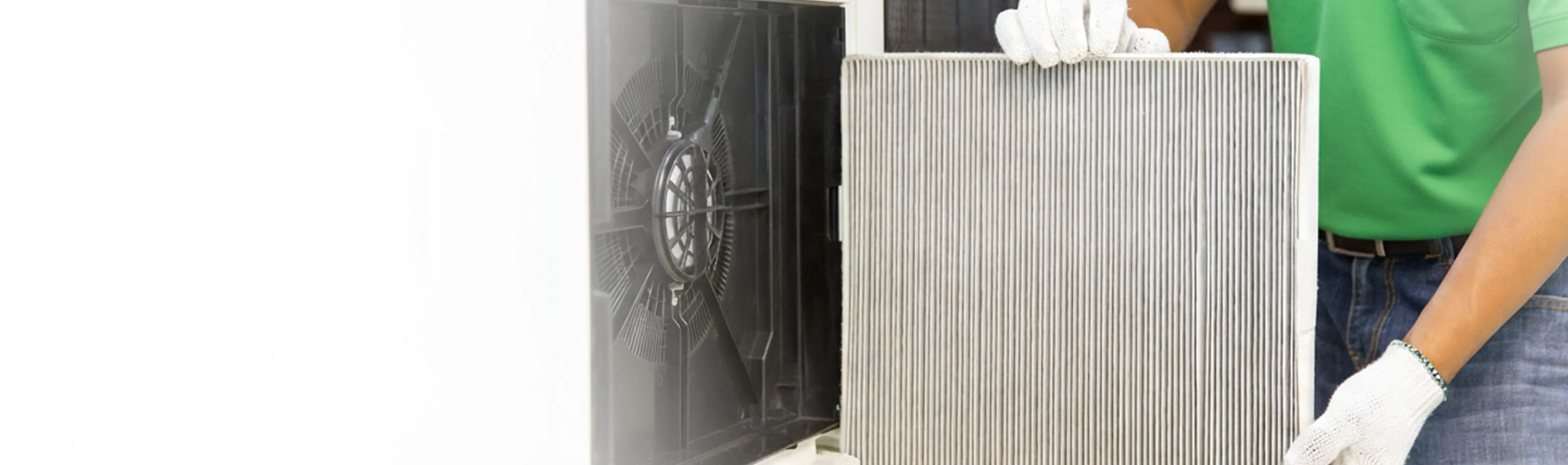 Rapid Response technician removing a used AC air filter for replacement as part of the air cleaning service