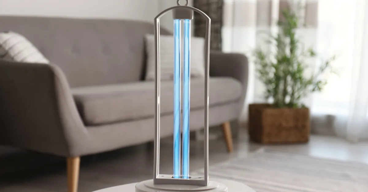 Portable UV air purifier glowing blue on a table in a modern living room