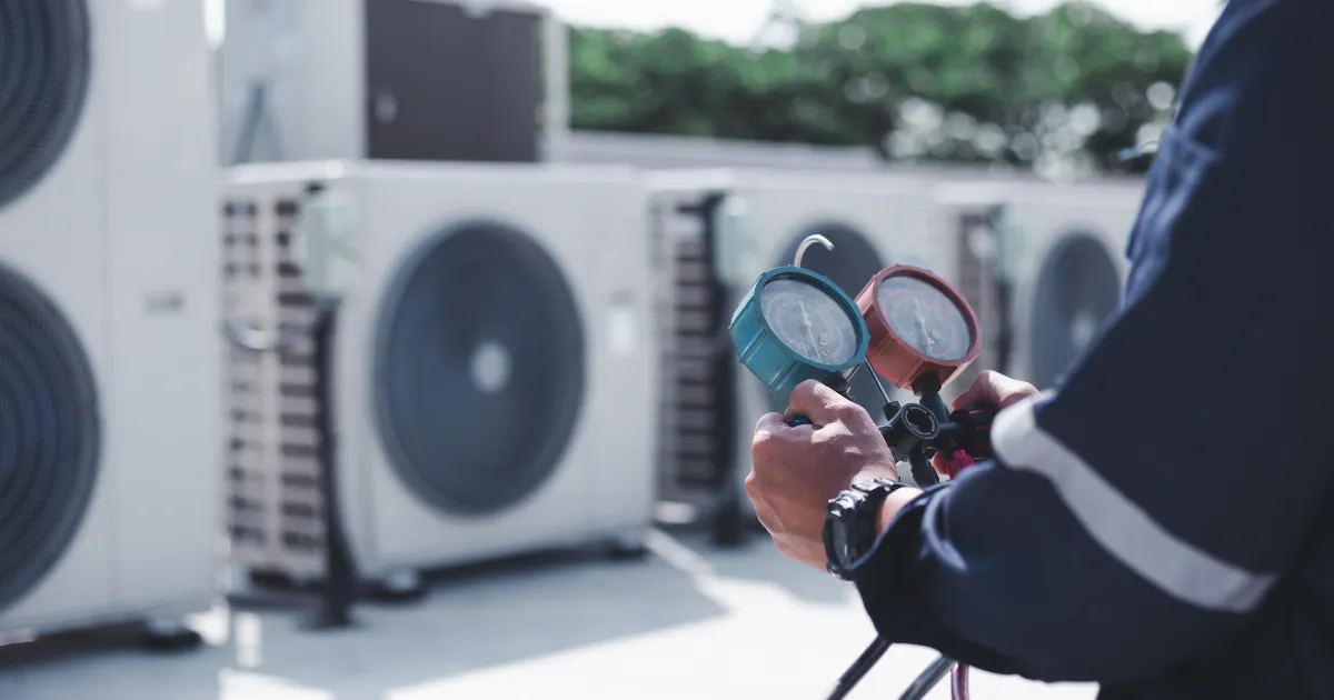 Rapid Response Specialist checking pressure gauges during routine inspection of outdoor HVAC units