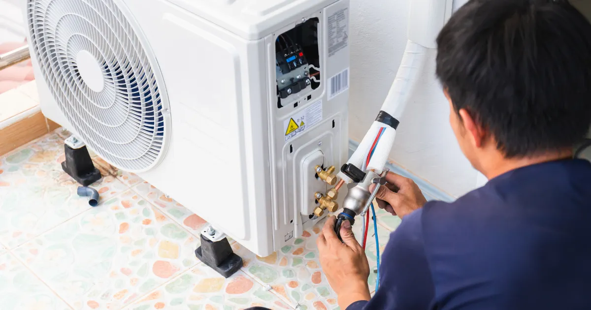 Outdoor AC condenser unit being serviced
